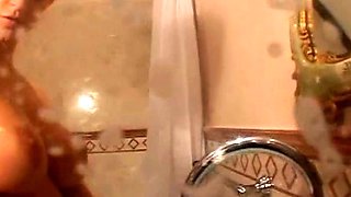 Hot babe with perfect big boobs taking shower