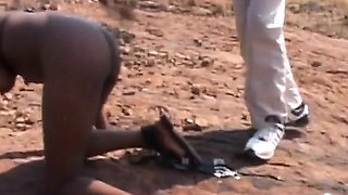 Rough outdoor spanking and tormenting with busty African