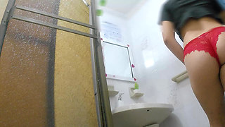 Athletic girl pissing in public bathroom