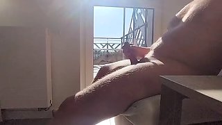 Dickflash in a hotel where a maid comes through the balcony and gets cum on her tits