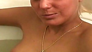 Hot Tanned Blonde Soaks in the Tub