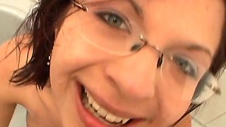 Hussy brunette wearing glasses gives her head and enjoys pee