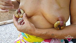 nippleringlover horny milf inserting huge nipple rings extreme stretched nipple piercings outdoors