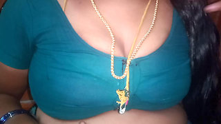 Tamil aunty squeezing her breasts when she is alone and unable to control her emotions.