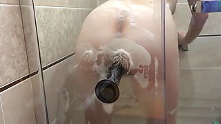 Pregnant milf in the lather in the shower masturbates with a dildo. Rubber dick fucks hairy pussy.