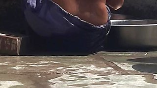 Desi sister-in-law is taking a bath in an open bathroom near the road on the edge of the forest on the farm