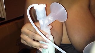 Ebony pumping milk out of her huge boobs and nipples