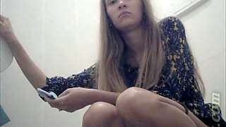 Long haired hot blonde girl pisses in the toilet room