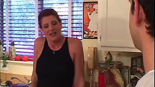 Mature redhead pounded in the kitchen