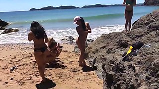 Horny babes masturbating on the beach
