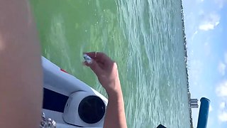 A black man fucks a juicy Cuban woman with fake big tits on jetski