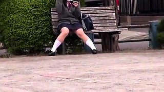 Sweet Japanese schoolgirl in uniform voyeur upskirt outside