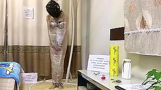 Chinese Slave bound in Chastity and heavy metal restrants