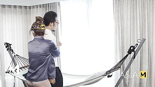 Bespectacled man reads papers before she seduces him
