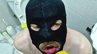 A slave is cleaning a dirty toilet when Dominatrix Nika comes to him with a strap-on and makes him take the strap-on in his mout