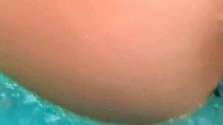 Busty Brunette with Glass Beads in the Indoor Pool