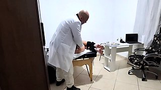 A MILF gets fingered by the proctologist during an anal