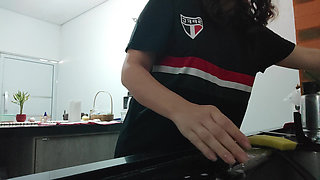Woman teasing while washing dishes. She loves to transmit to the voyeurs on duty