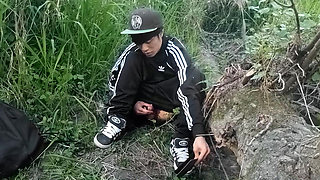 Cute Asian gay twink in a black-and-white adidas tracksuit and Campus sneakers masturbates and cums outdoors