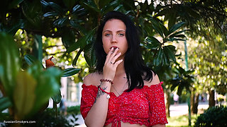Sultry Brunette in Red Dress Smoking Rolled Cigarette