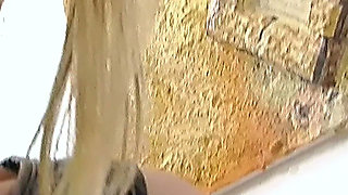 Blonde in Pantyhose Plays with a Glass Toy on the Office Chair