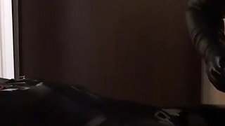 Oil body in latex catsuit