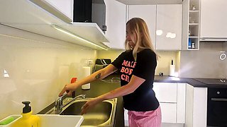 A Braless Blonde in Pajama Shorts Flashes Her Bare Pussy While Standing in the Kitchen