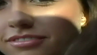 Vibrator Pressed Deep Between a Blonde's Legs - Long Haired Brunette Keeps It Buzzing on the Cream Couch