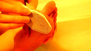 Brunette with foot fetish rubs big dick with her feet in POV